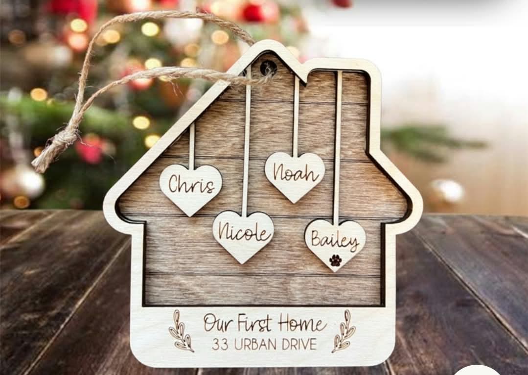 House-shaped ornament with hanging hearts naming Chris, Nicole, Noah, and Bailey