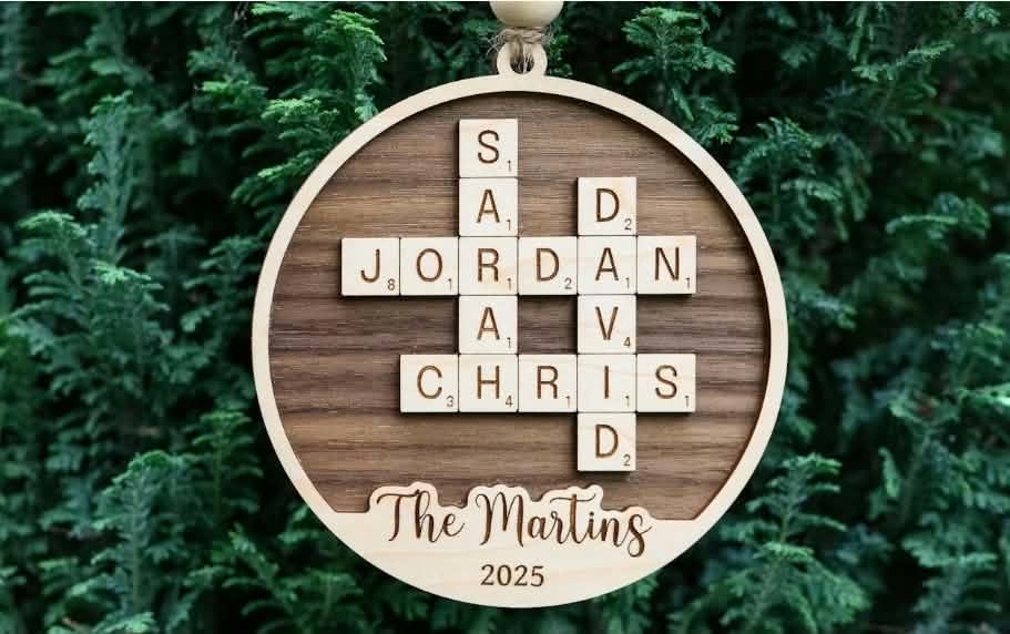 Round wooden ornament with family names laid out like a crossword, The Martins 2025